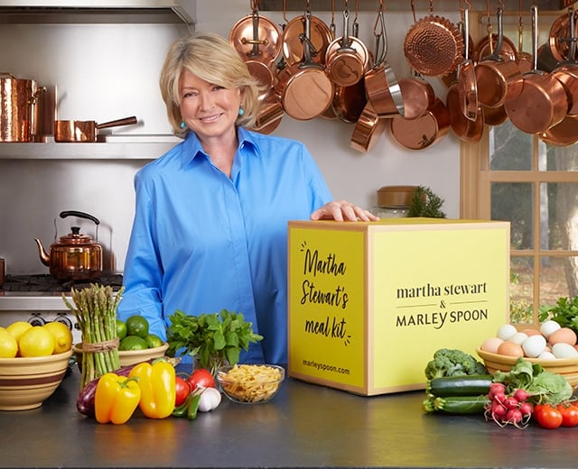 Martha Stewart with ingredients, a Martha & Marley Spoon meal kit, 2 dish bags and 2 recipe cards
