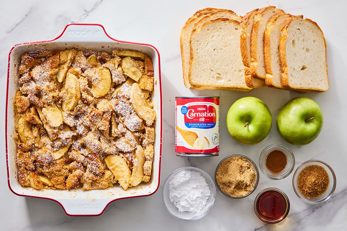 Apple French toast with ingredients laid out on a marble countertop