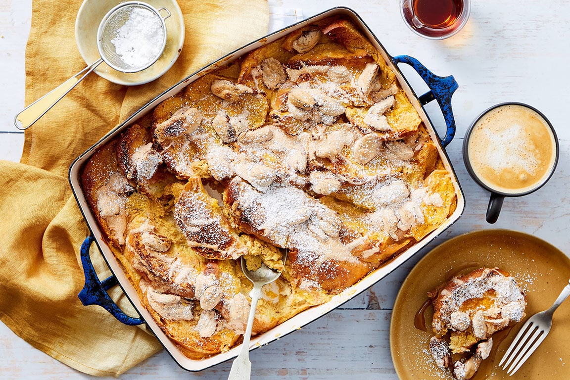 Pumpkin French toast bake with maple syrup on a rustic tabletop